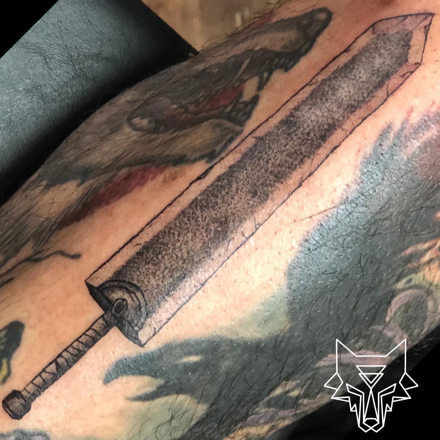 Tattoo of Guts' Dragon Slayer sword from Berserk on the thigh, depicted in a detailed, textured style